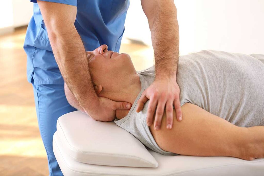 A chiropractor gently adjusts the spine of a relaxed adult in a calm clinic setting.