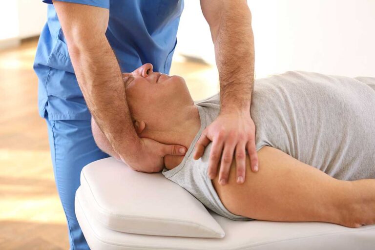 A chiropractor gently adjusts the spine of a relaxed adult in a calm clinic setting.